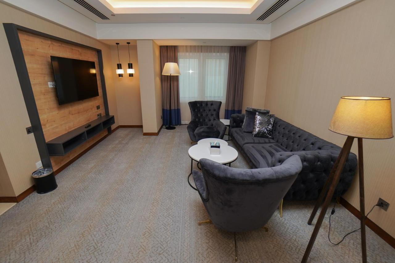 The Grand Lux Hotel Doha Exteriör bild A living room in a hotel suite