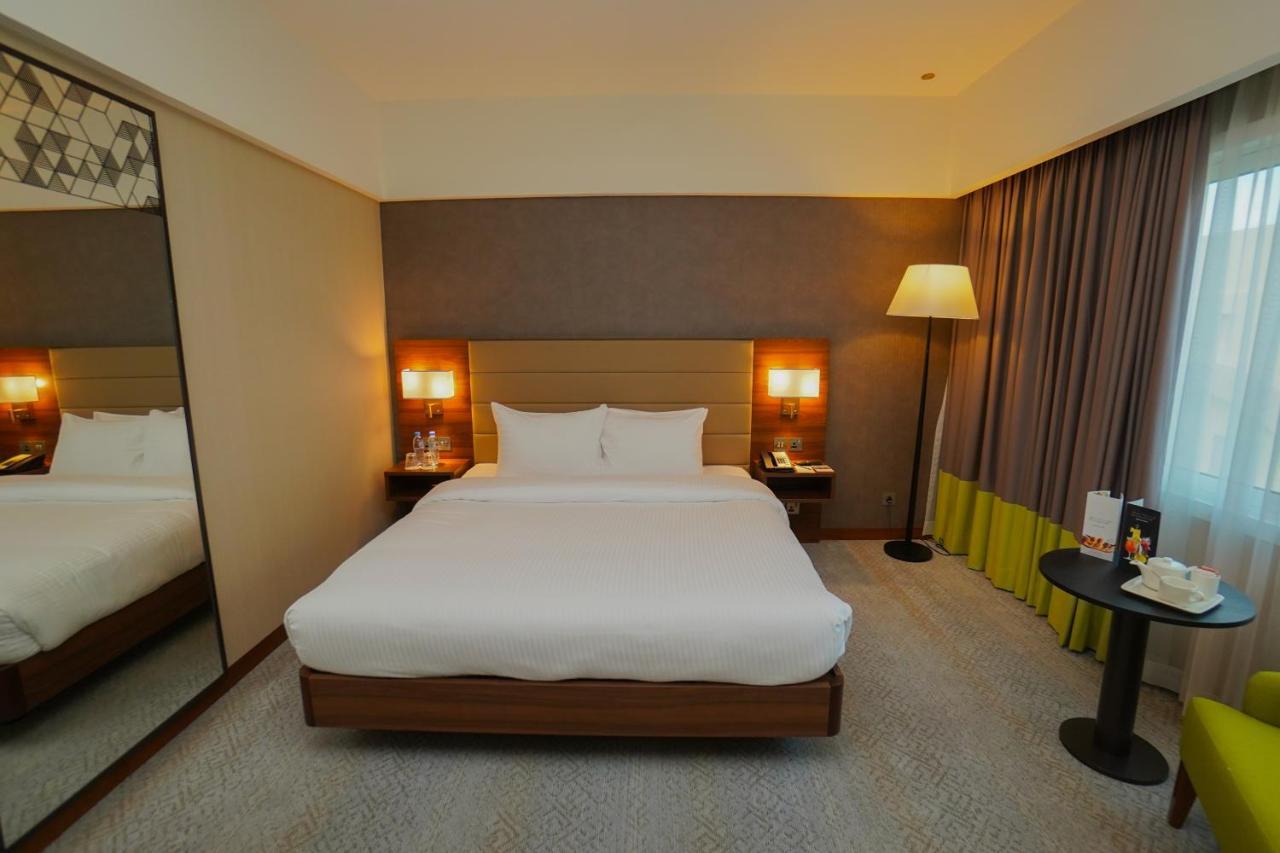 The Grand Lux Hotel Doha Exteriör bild A room at the hotel