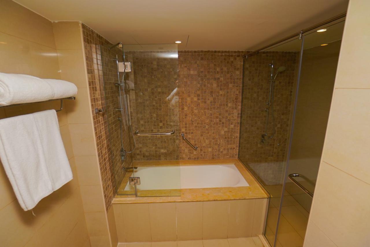 The Grand Lux Hotel Doha Exteriör bild A bathtub with a shower enclosure